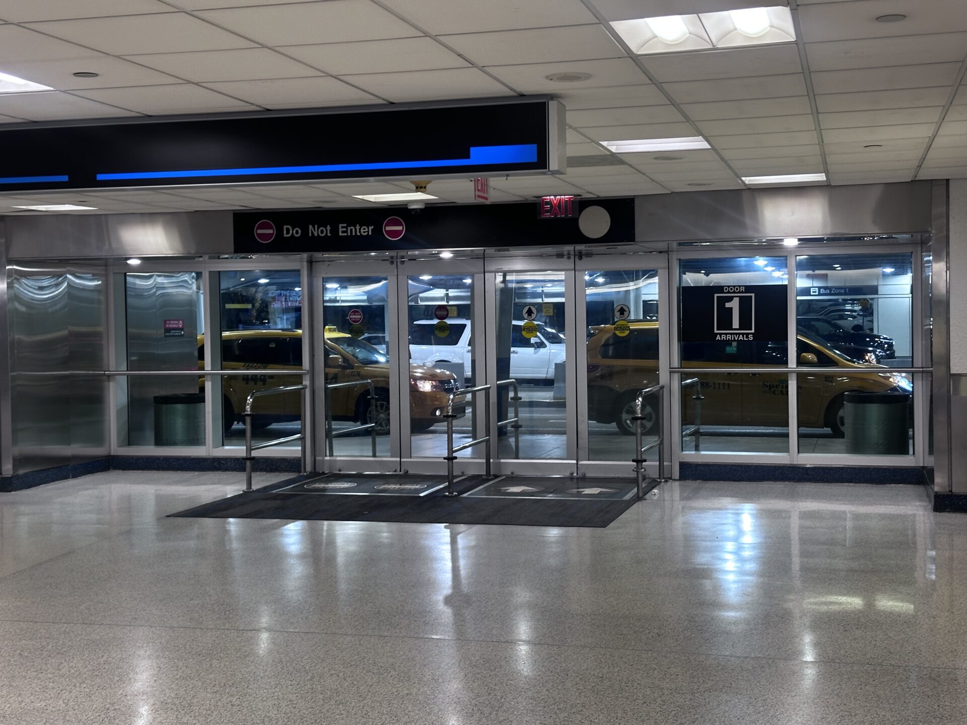 Door 1 Arrivals sign at Miami International Airport.